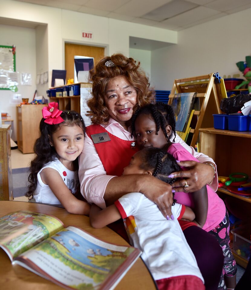 Foster grandparent Loretta Stovall, 84, gets goodbye hugs as she reaches the end of her day...