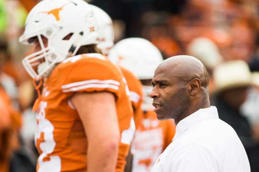 Texas head coach Charlie Strong watches his team warm up before an NCAA football game...