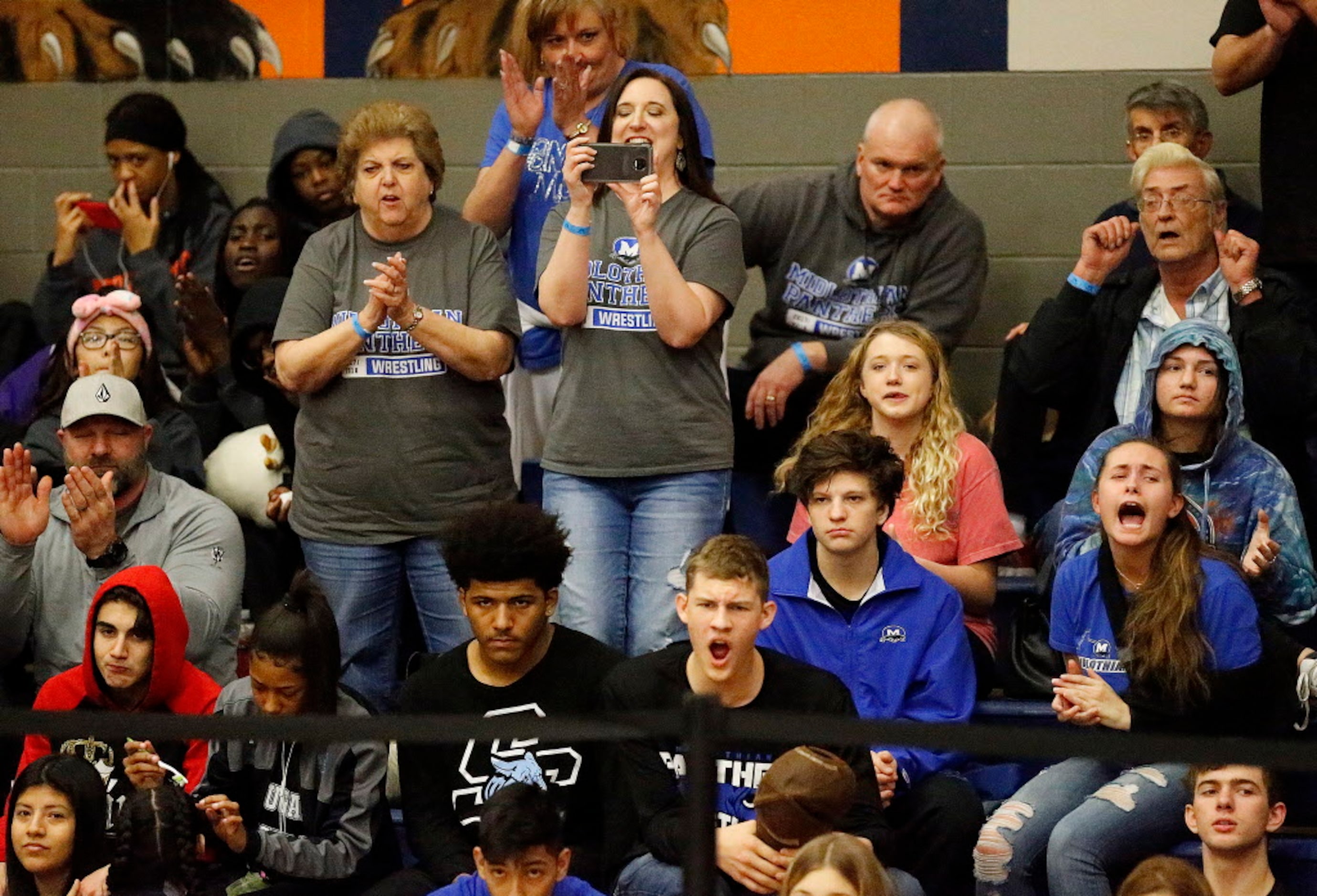 Fans cheer the action during the 5A Region II wrestling meet held at Wakeland High School in...