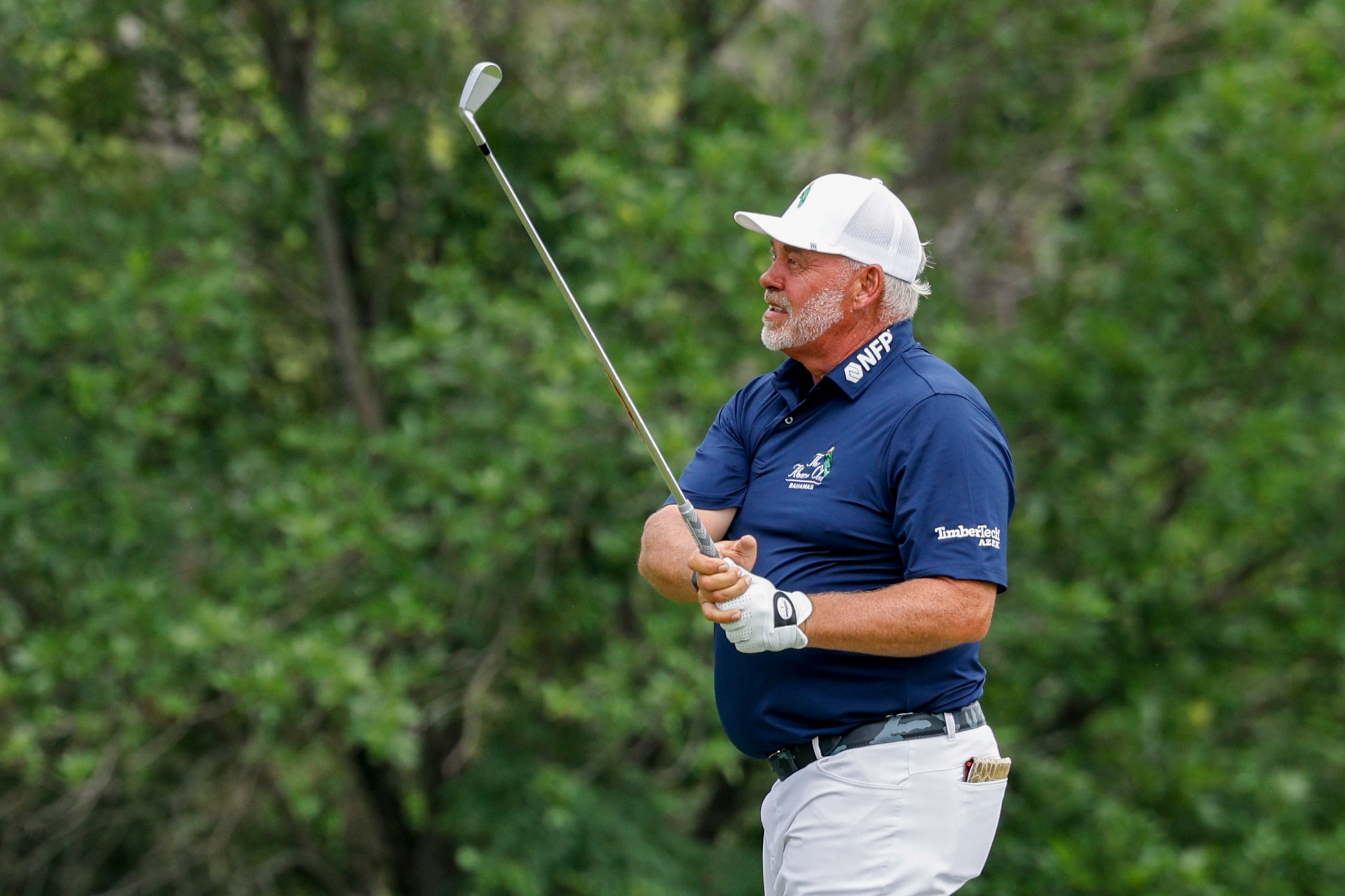 Darren Clarke of Northern Ireland watches his shot on the 18th hole during the first round...