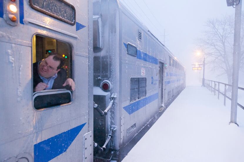  A Long Island Rail Road conductor signals the departure of a Penn Station-bound train in...