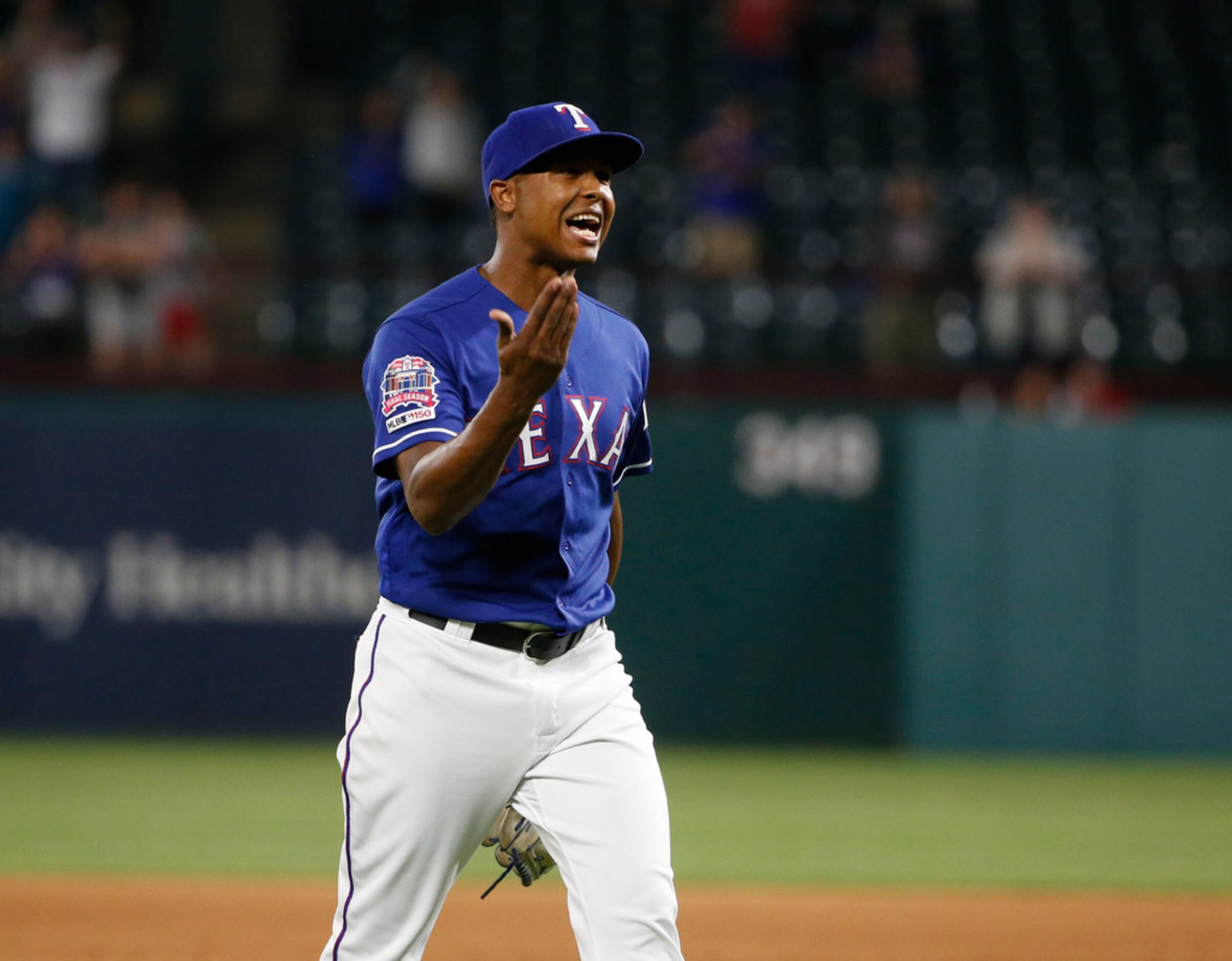 Texas Rangers relief pitcher Jose Leclerc reacts after getting out of a bases-loaded jam...