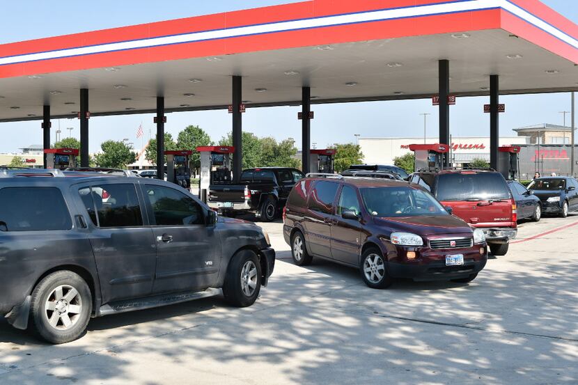Customers waited in line just before Labor Day weekend to fill up their vehicles at a...