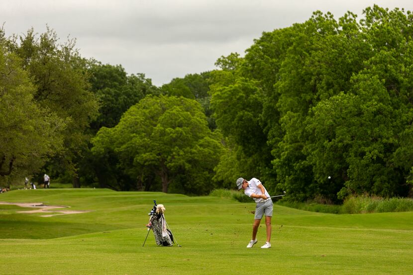 JJ PearceÕs Preston Stout hits from the fairway on the 14th hole during the final round of...