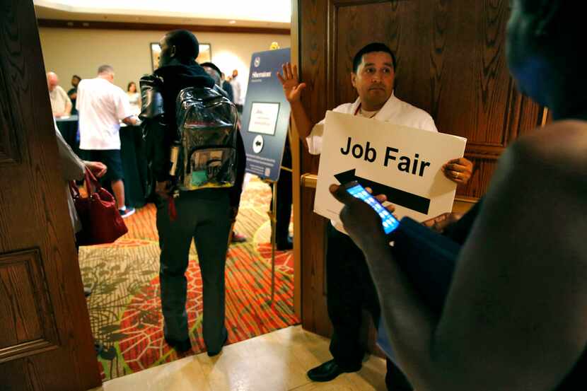 Eric Martinez with Workforce Solutions Greater Dallas directs people during the You're Hired...