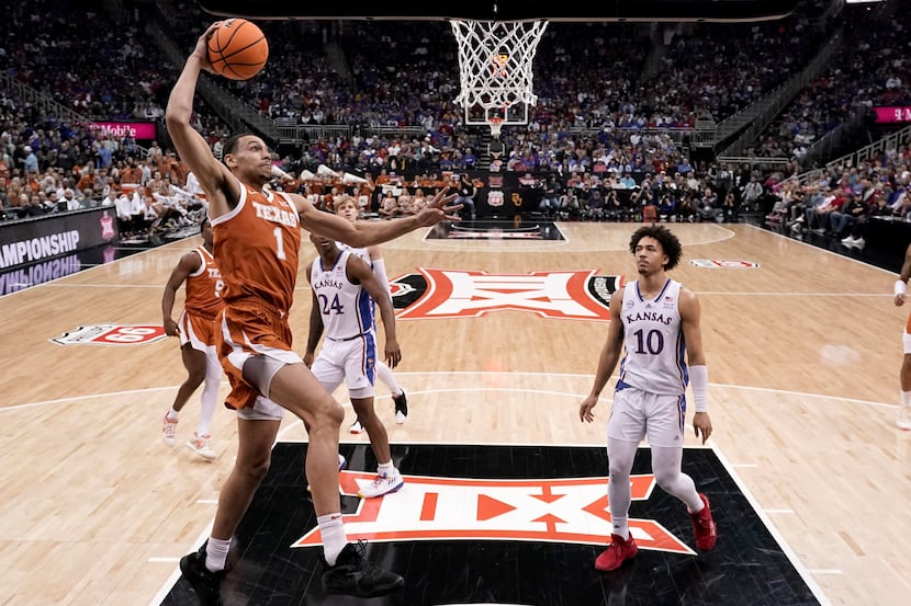 Texas forward Dylan Disu (1) dunks the ball during the first half of the NCAA college...