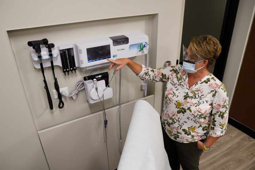 Registered nurse Jodyne Schlachter explains the technology in one of the clinical rooms at...