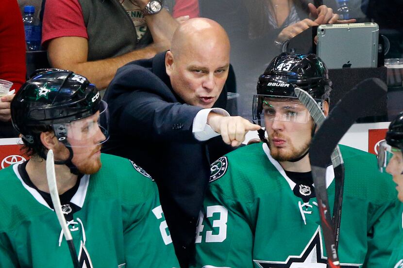 Dallas Stars head coach Jim Montgomery gives instruction to right wings Brett Ritchie (25)...
