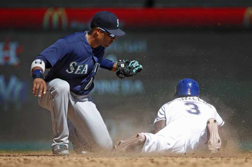 Texas Rangers runner Delino DeShields (3) is tagged out by Seattle Mariners second baseman...