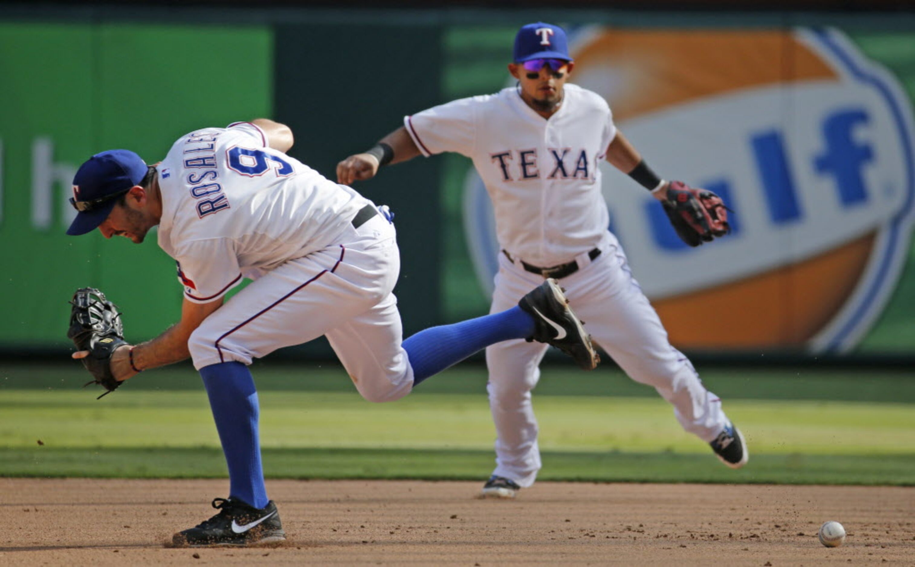 Texas first baseman Adam Rosales can't can't get the handle on Josh Reddick's infield hit in...