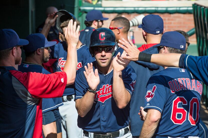 Cleveland Indians right fielder David Murphy (7) is congratulated by his team during the...