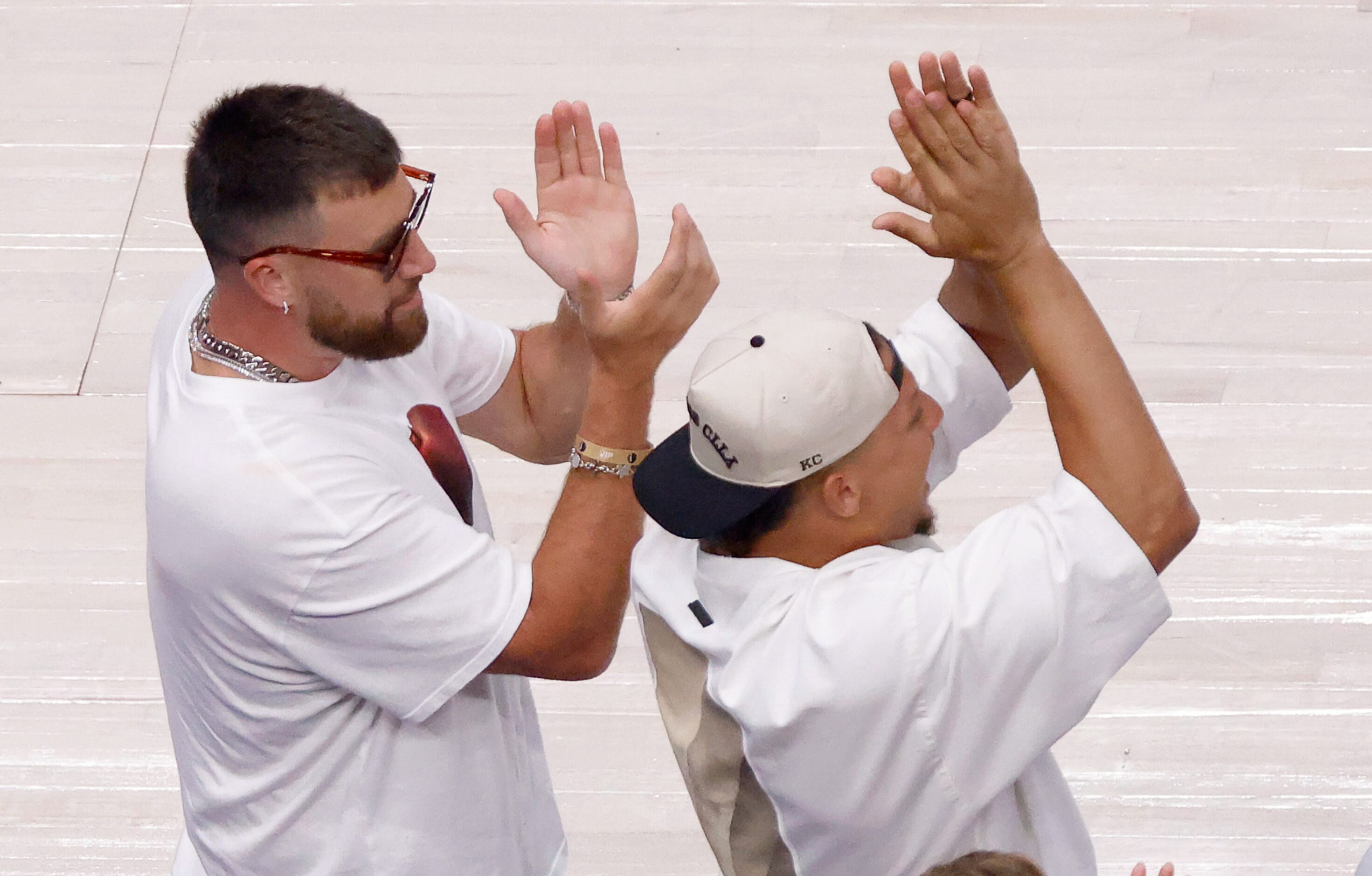 Kansas City Chiefs football players Travis Kielce (left) and Patrick Mahomes cheer on the...