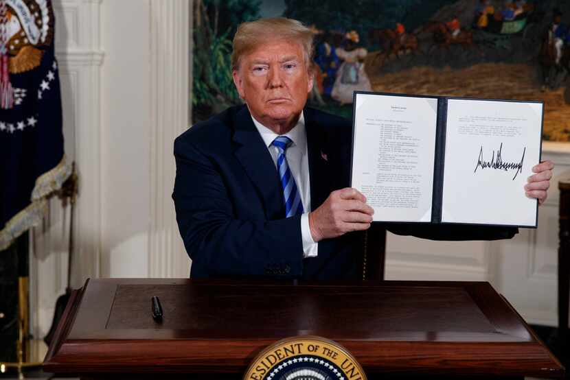 President Donald Trump shows a signed Presidential Memorandum after delivering a statement...