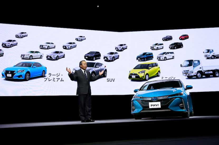 Toyota Motor Corporation's Chairman of the Board of Directors Takeshi Uchiyamada speaks with...