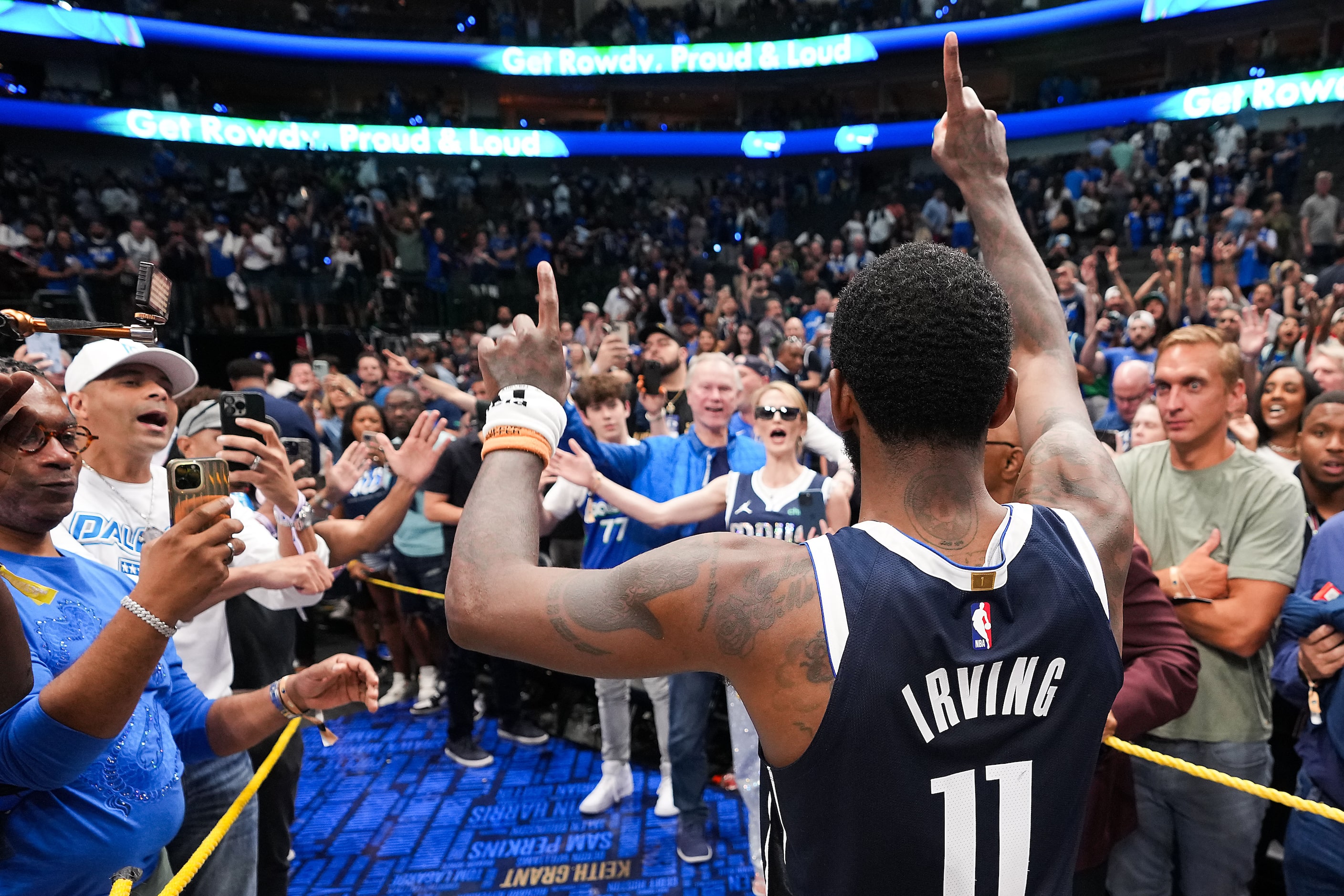 Dallas Mavericks guard Kyrie Irving holds up one finger to the crowd after a 116-107 victory...