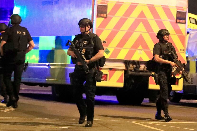 Armed police respond after reports of an explosion at Manchester Arena during an Ariana...