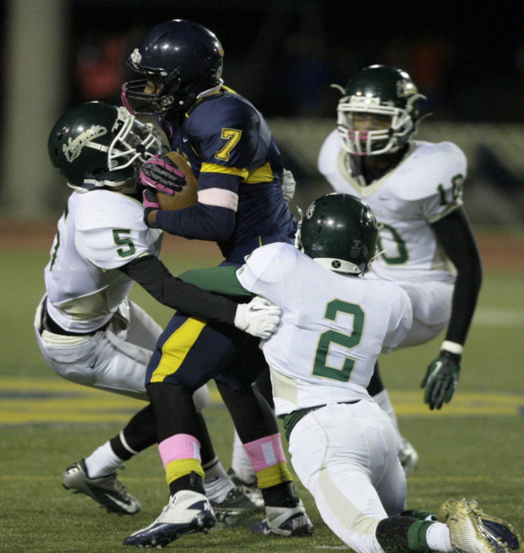 Frisco Centennial running back Lakeylon Rice (20) is stopped by R.L. Turner players John...