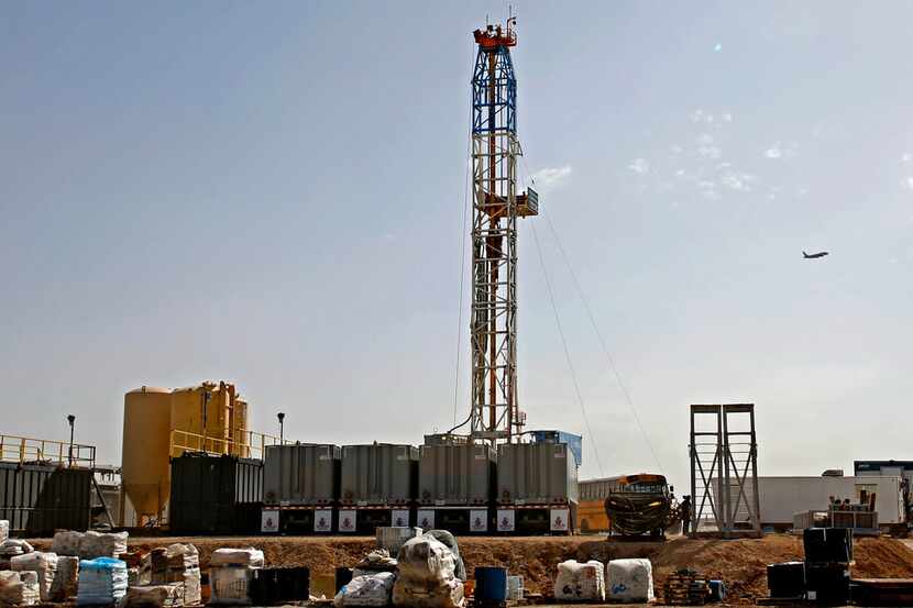 In this April 17 photo, a Latshaw Drilling Rig operates on a Diamondback oil and gas...