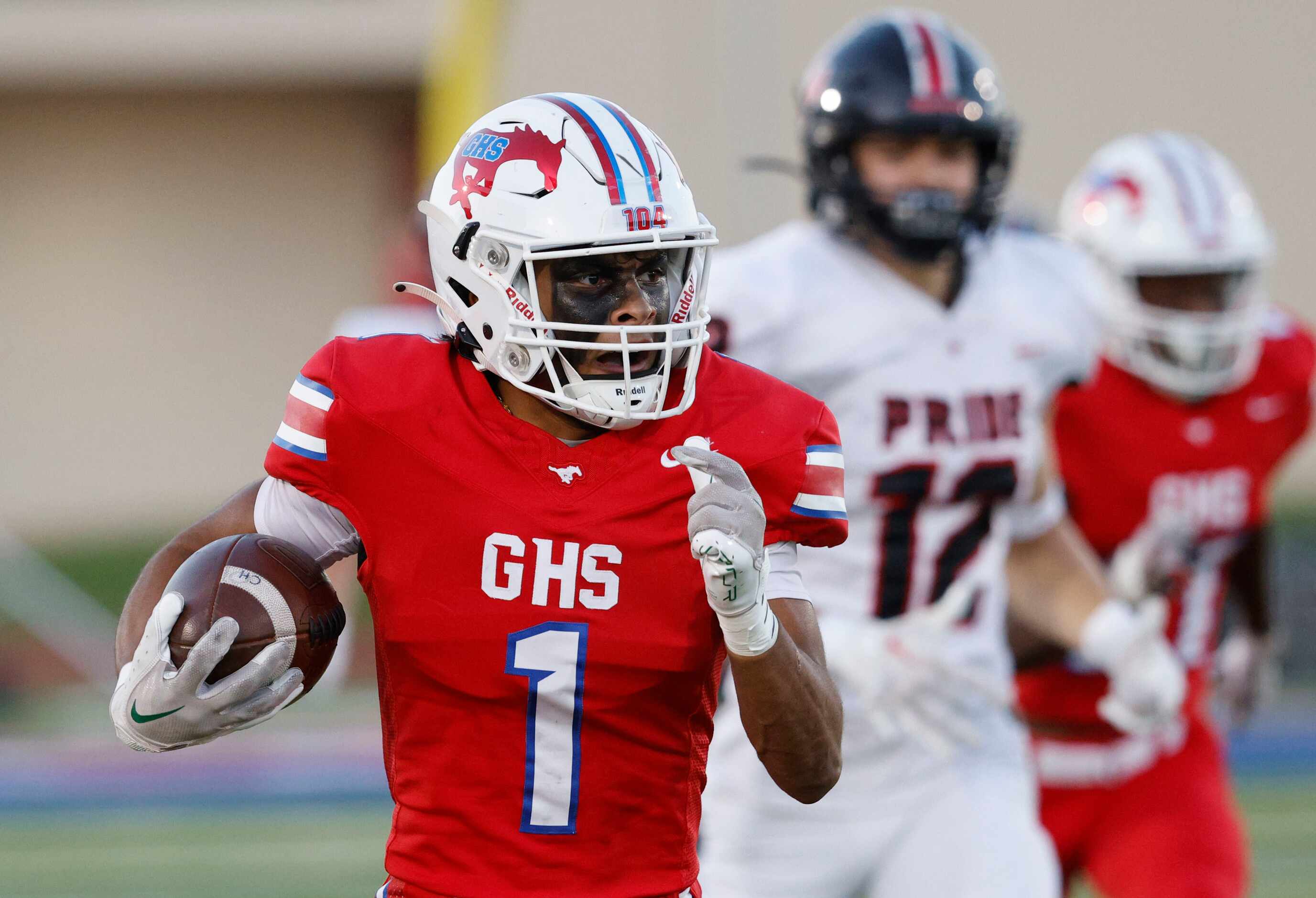 Grapevine's Bryson Davis (1) carries the ball against Colleyville Heritage during the first...