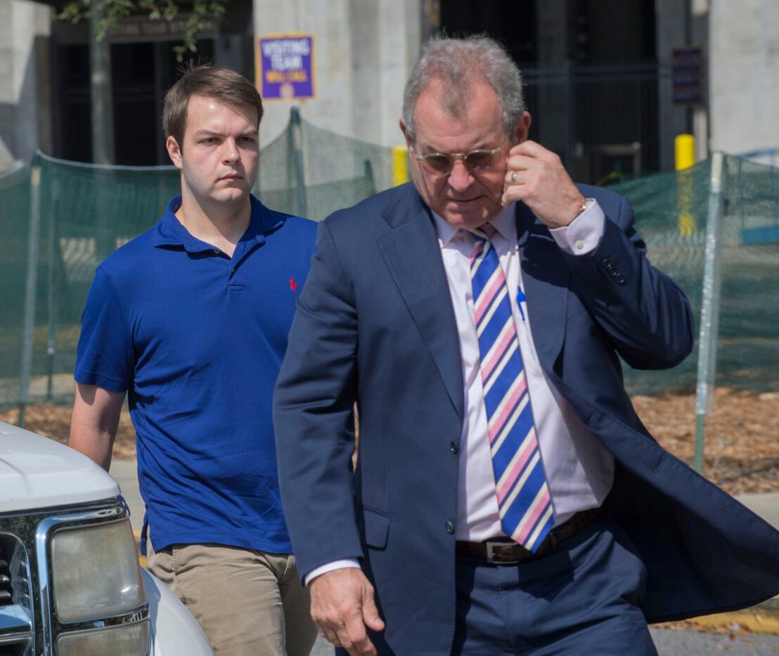 Elliott Eaton (left) accompanied by attorney J. Rodney Messina,  walks to the entrance of...