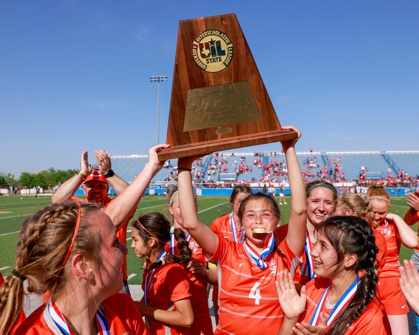 Celina defender Makenna Brantley (4) raises the Class 4A girls soccer state championship...