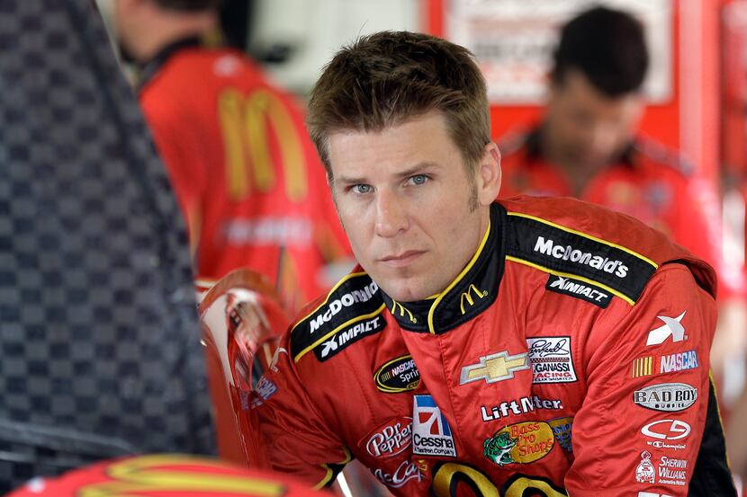FILE - In this Feb. 22, 2013 file photo, Jamie McMurray climbs into his car during a...