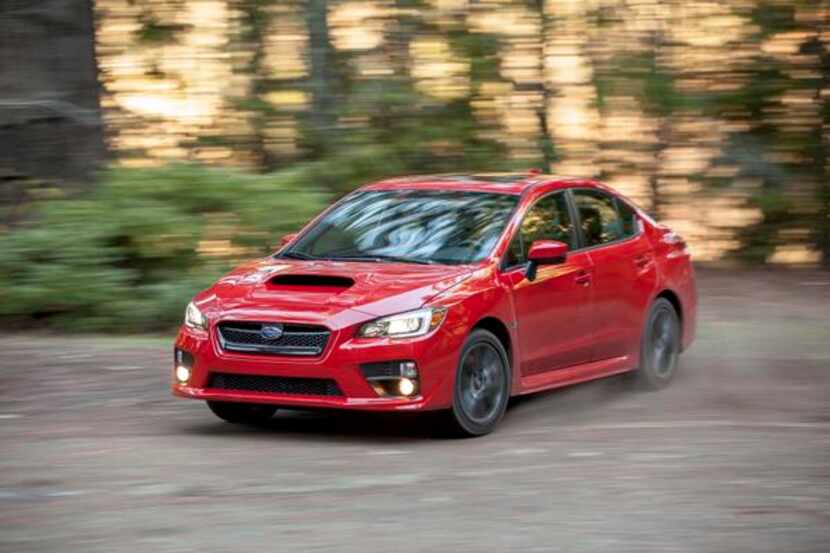 The 2015 Subaru WRX  may seem squat and blocky, but its slightly flared fenders, lower...