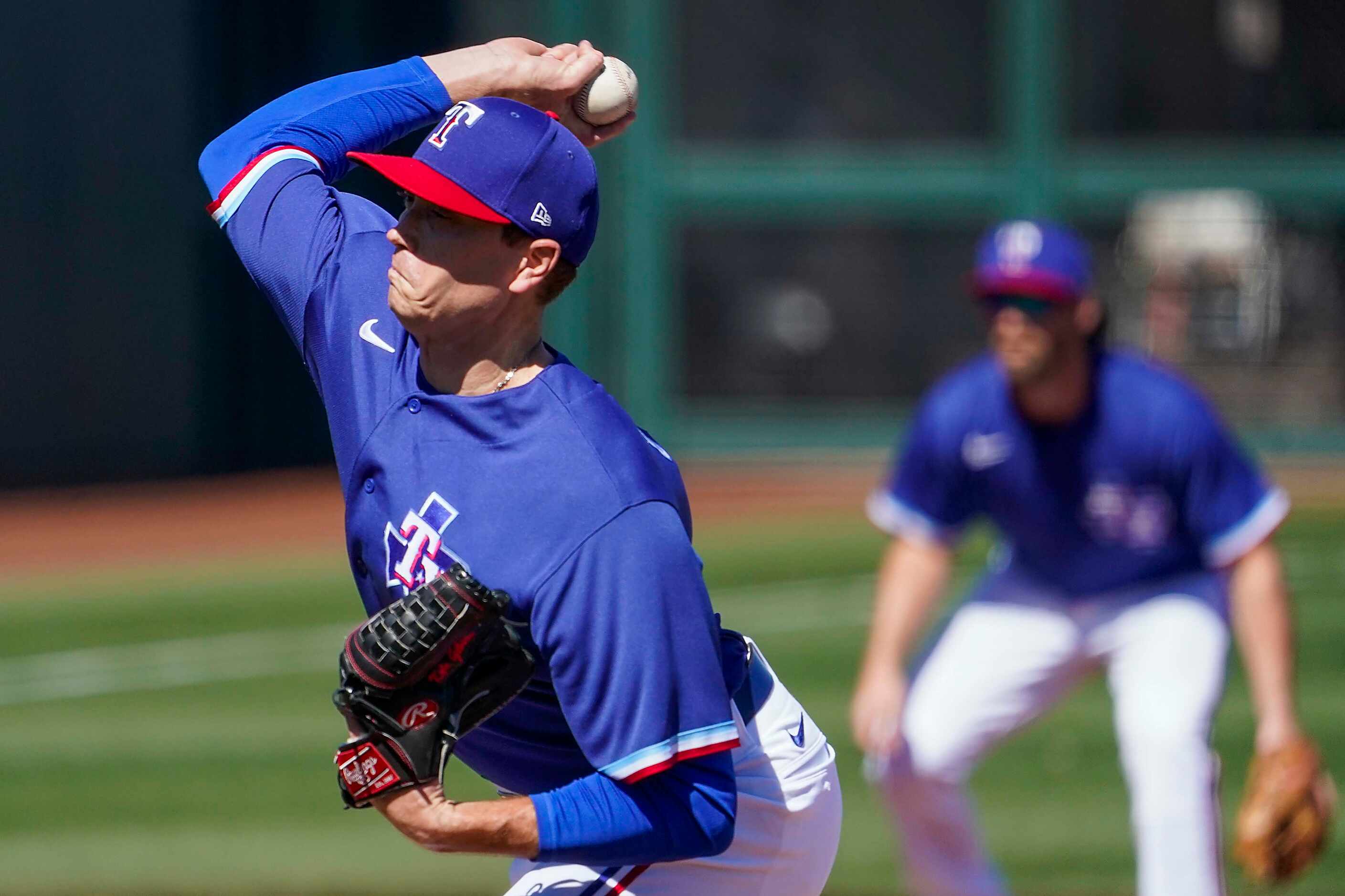 Texas Rangers pitcher Kyle Gibson delivers during the first inning of a spring training game...