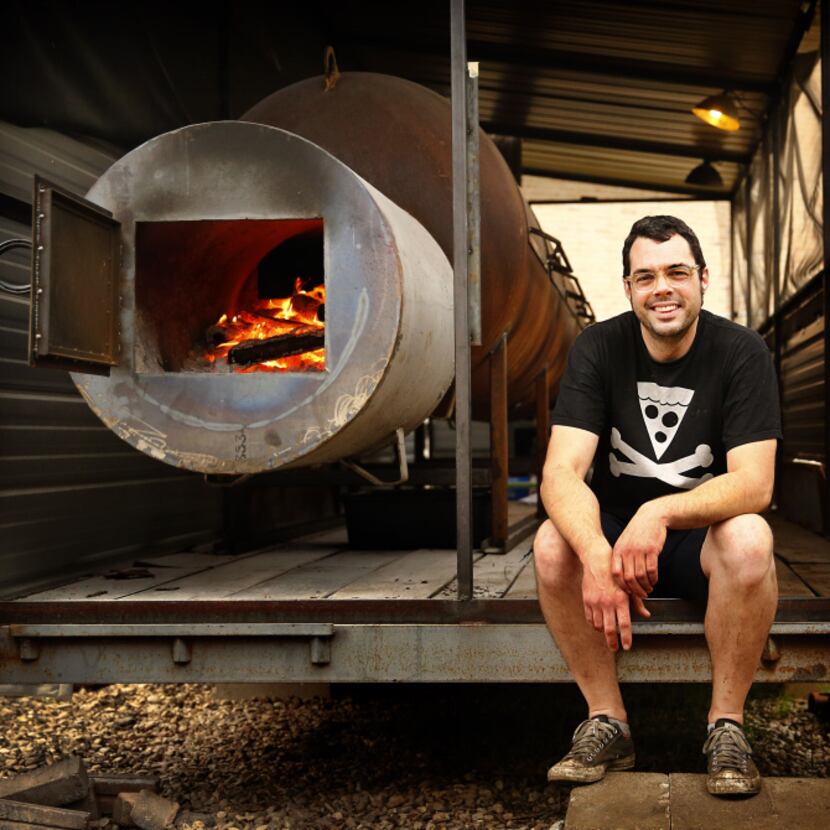 Pitmaster Aaron Franklin poses with his newest smoker behind Franklin Barbecue in Austin.