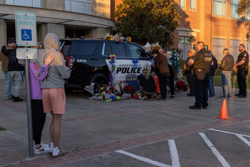 Family and friends of Greenville police Officer Cooper Dawson, who was fatally shot Monday,...