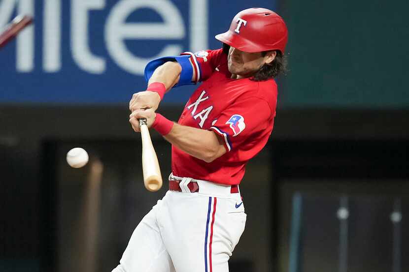 Texas Rangers third baseman Josh Smith connects on a leadoff single during the first inning...