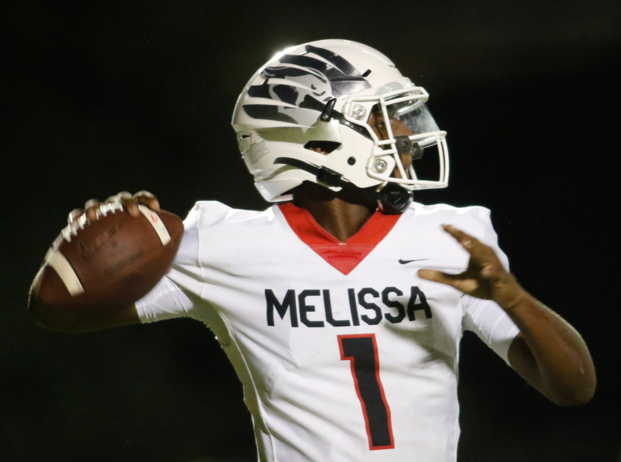 Melissa quarterback Brendon Lewis (1) launches a pass downfield during first half action...