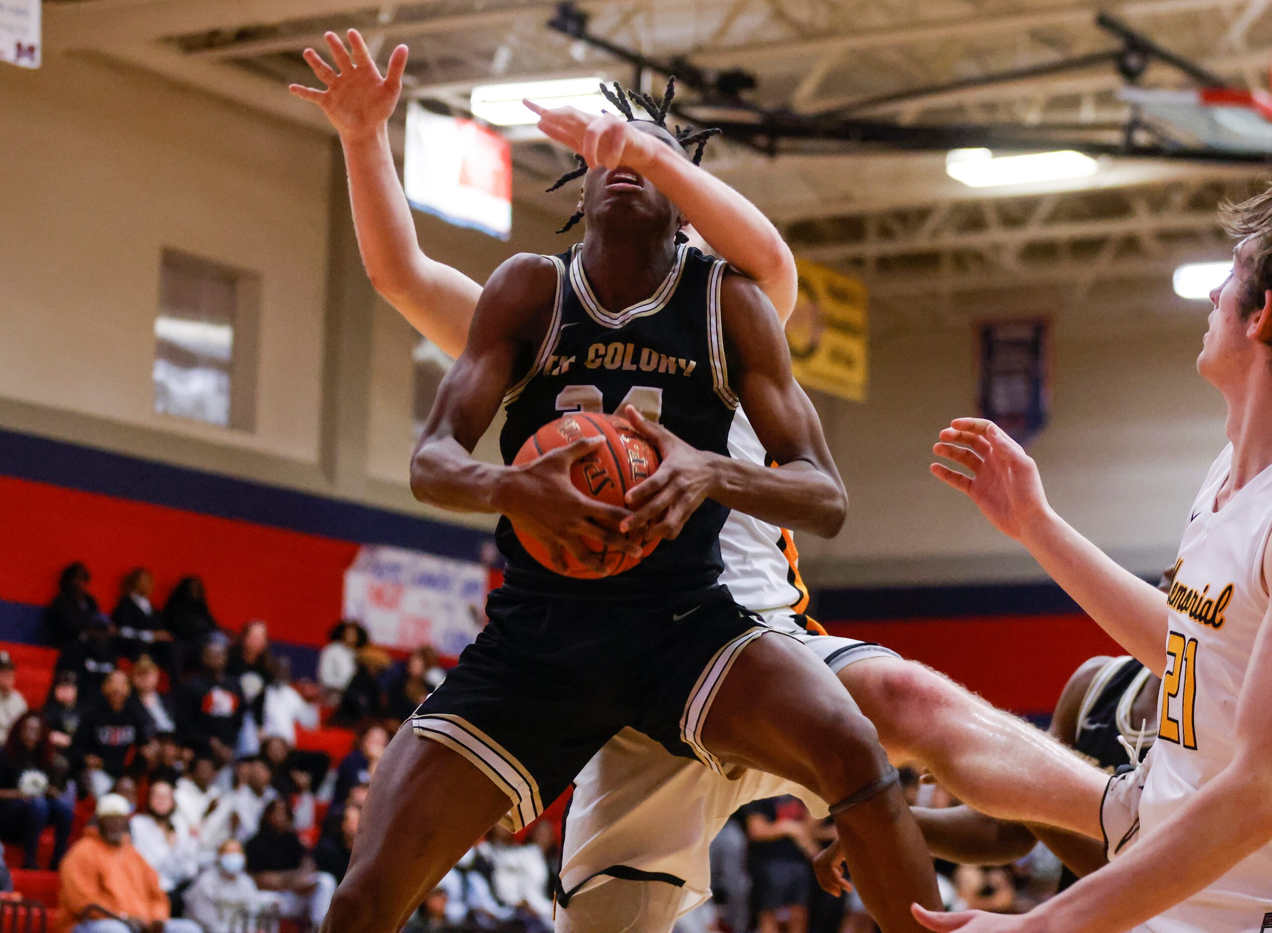 The Colony’s Xavier McKinney (24) rebounds the ball as Memorial’s Mason Wujek (32) defends...