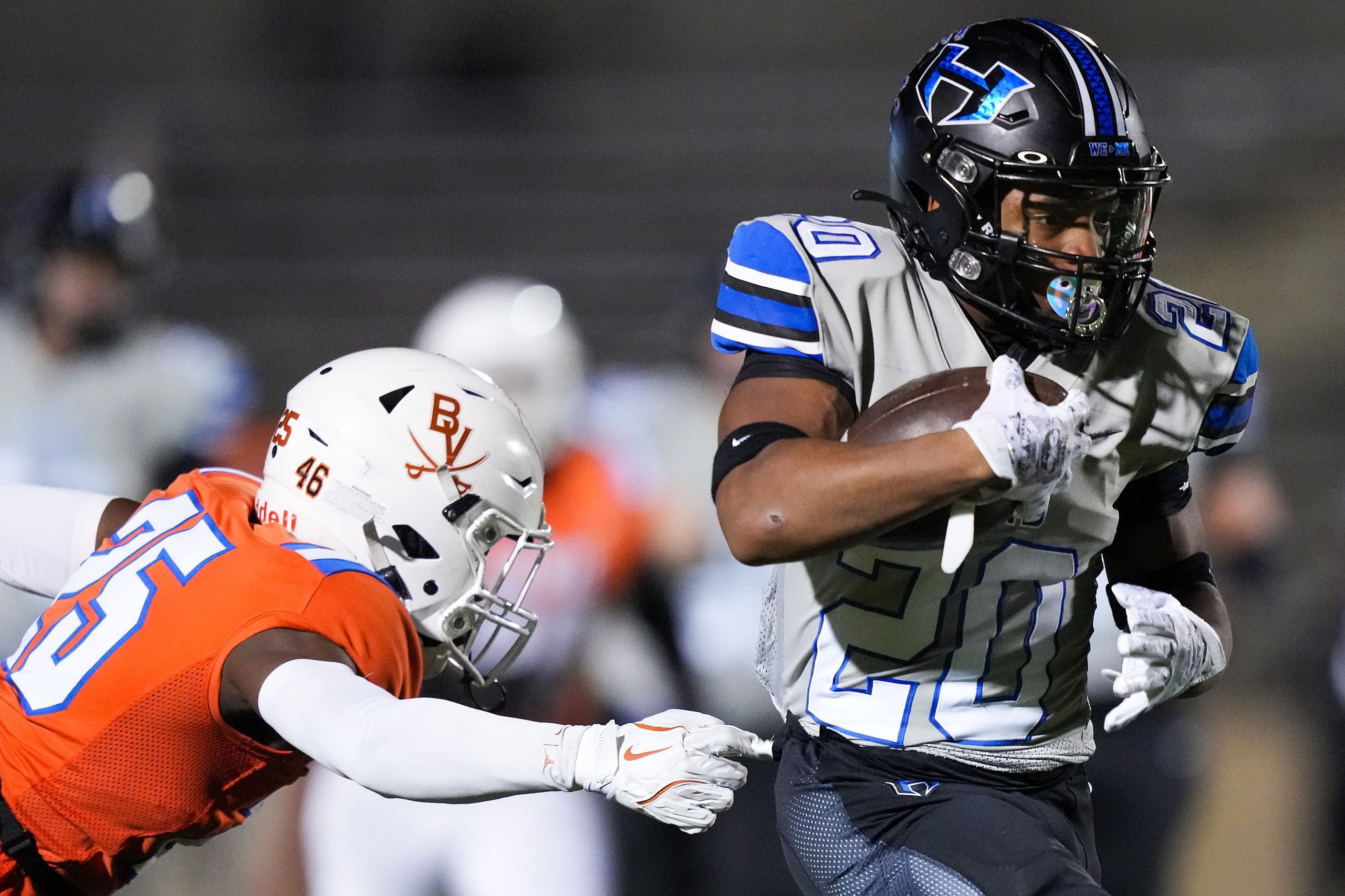 Hebron running back Ahmad Ware (20) gets past Arlington Bowie linebacker Kenri Madrid (35)...