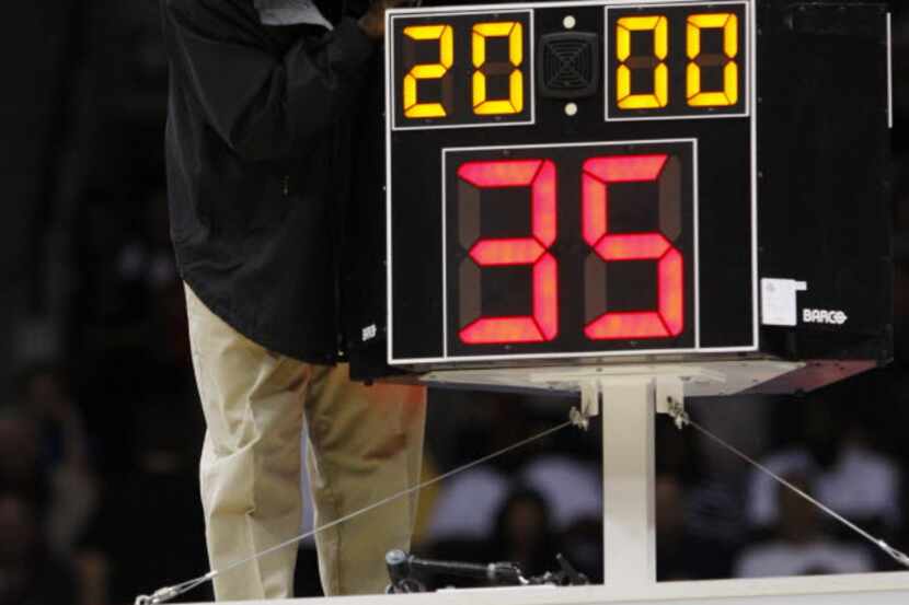 FILE - In this March 19, 2010, file photo, a technician adjusts a shot clock after it...