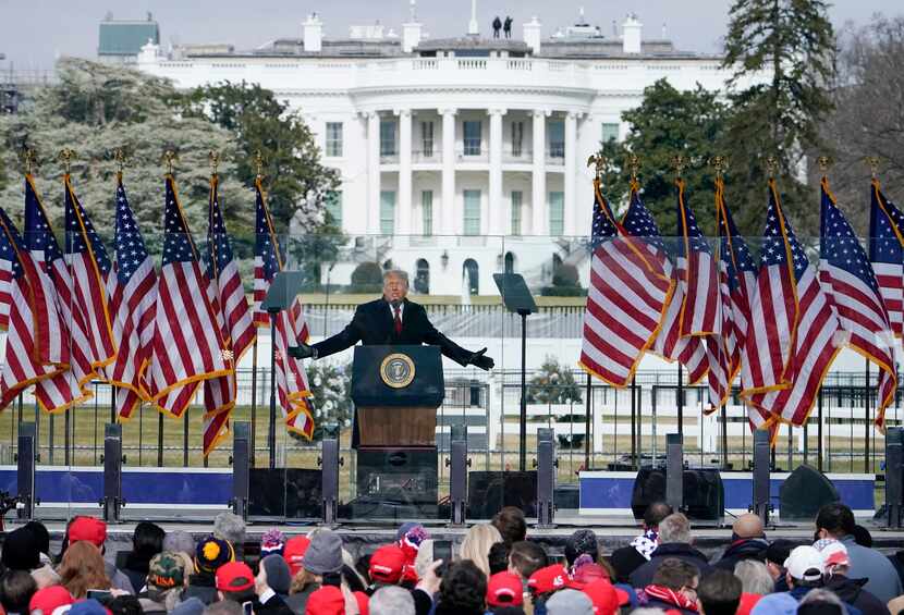 FILE - With the White House in the background, President Donald Trump speaks at a rally in...