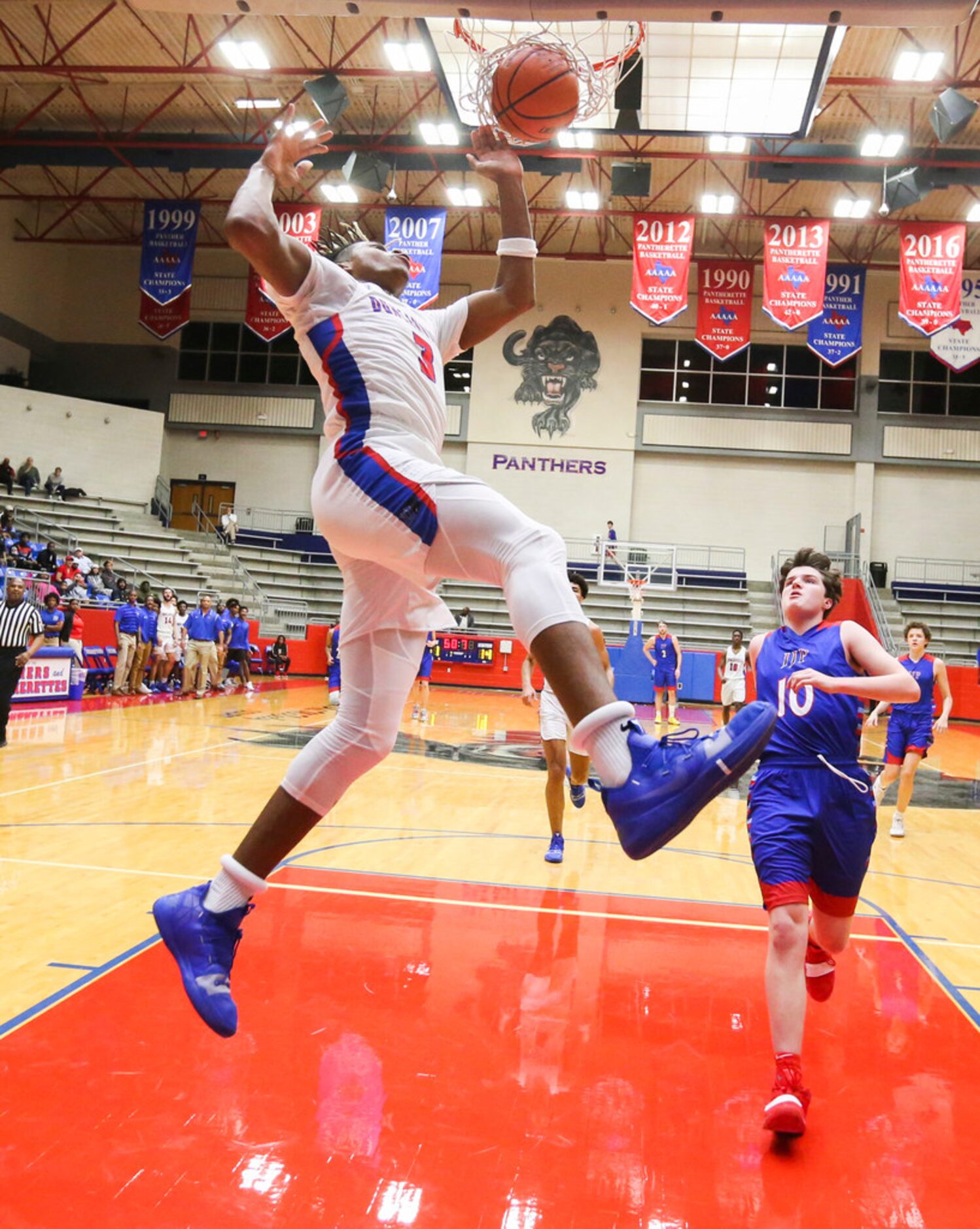 Duncanville guard Jahmius Ramsey (3) dunks the ball past J. J. Pearce guard Walker Timme...