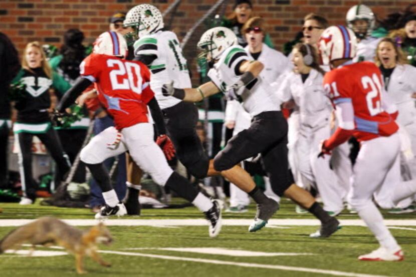As Southlake Carroll quarterback Kenny Hill runs down the sideline to score the game-winning...