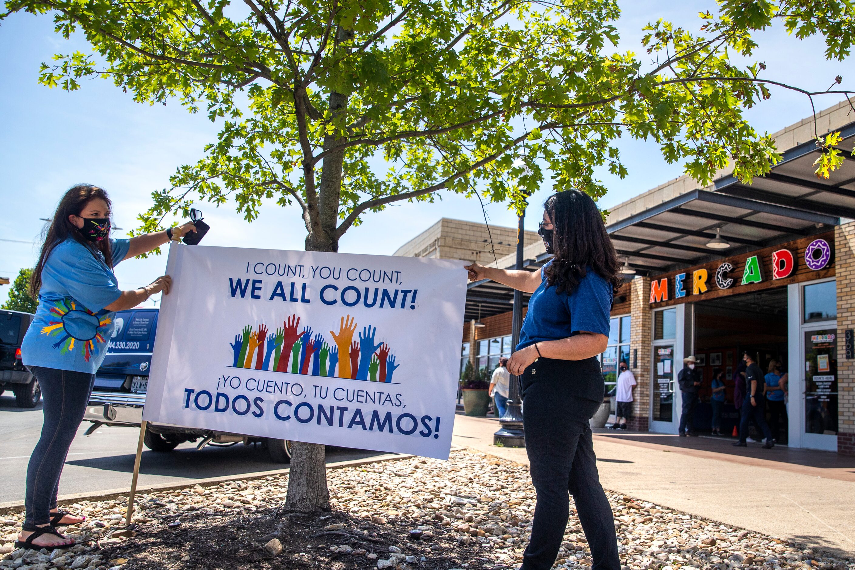 Minerva Rodriguez and Leticia Tudon place a flag at the entrance to one of the locations for...