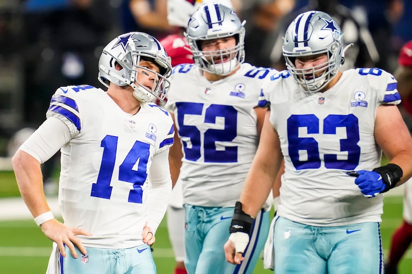 Dallas Cowboys quarterback Andy Dalton (14) reacts after being sacked by Arizona Cardinals...