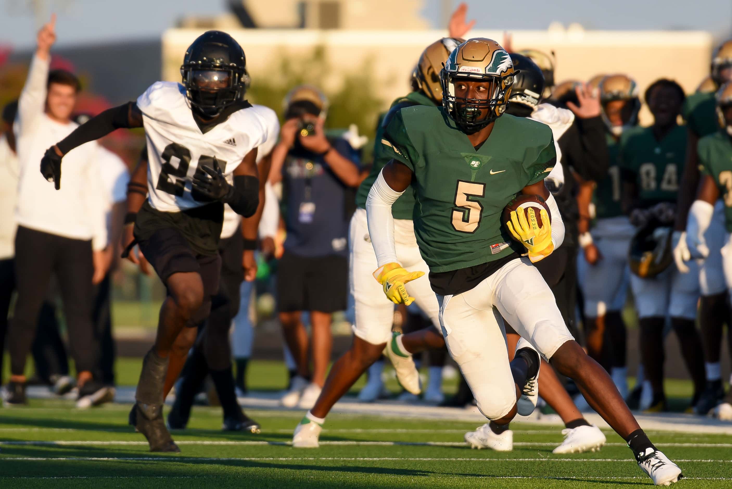 DeSoto senior Tre Wisner (5) runs up the field after catching a pass during DeSoto’s home...