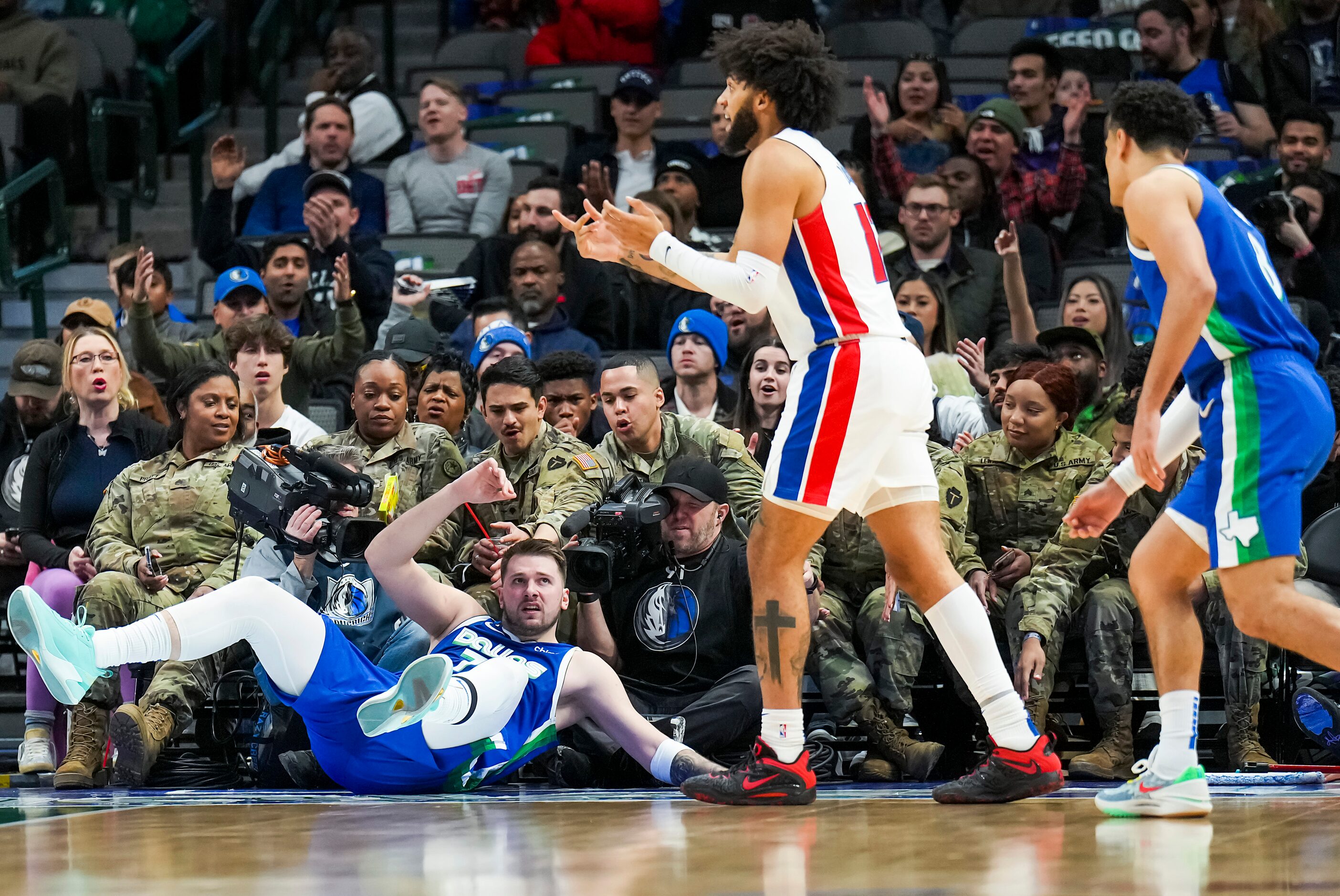 Dallas Mavericks guard Luka Doncic (77) slides into the first row on Seats for Soldiers...