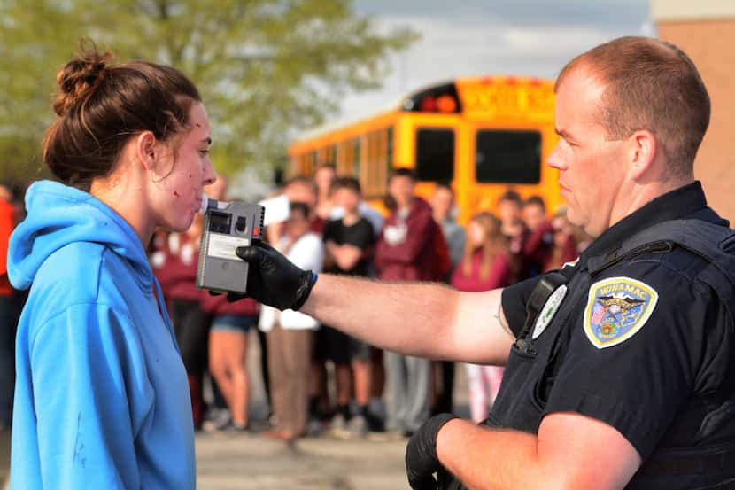 Winamac, Ind., police Officer Aaron Spanley administers a field sobriety test to Isabelle...