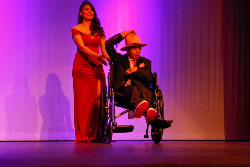 Jazmine Valdez Ruiz walks on stage with Aaron Osorio during a fashion show at Thomas...