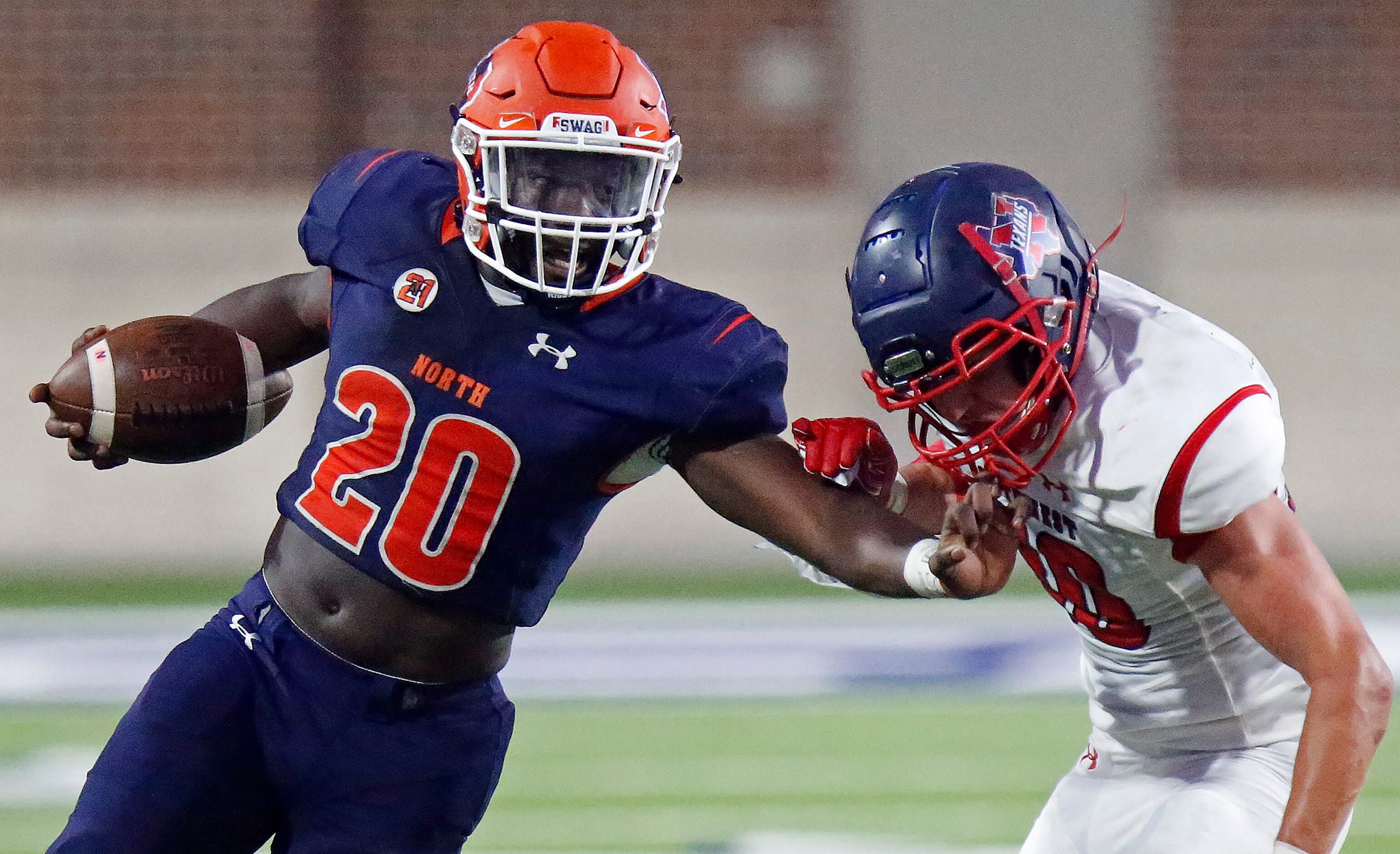 McKinney North High School Elijiah Alexander (20) gets away with a facemark on the stiff arm...