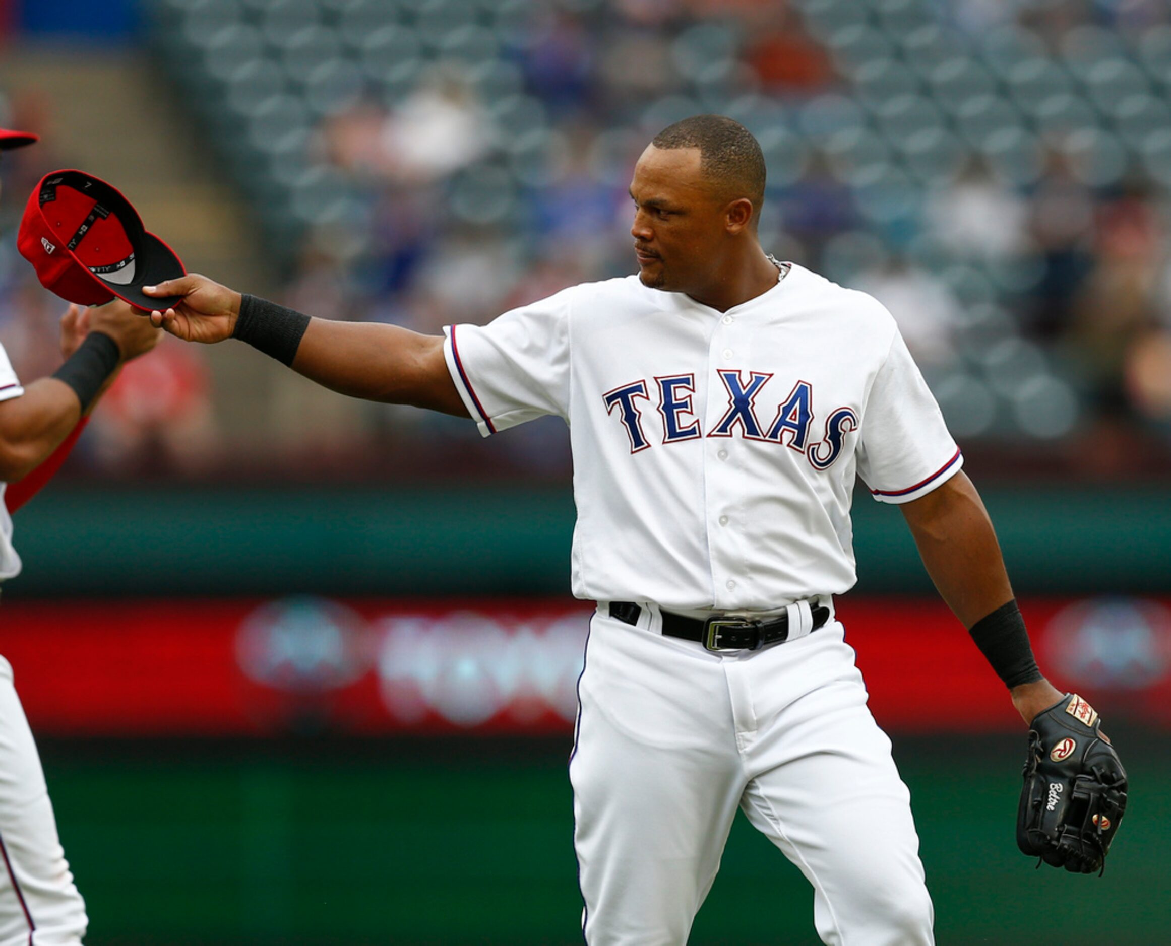 Texas Rangers' Adrian Beltre tips his hat to the Seattle Mariners bench after being relieved...