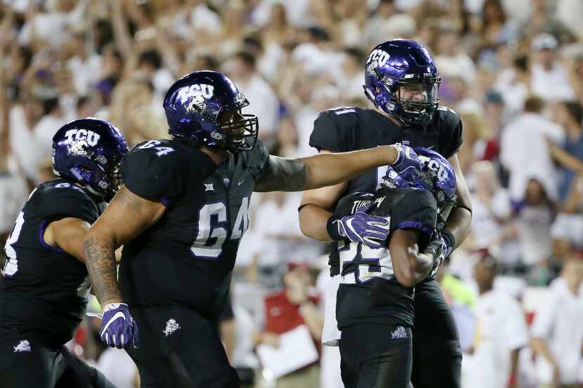 Teammates celebrate with TCU wide receiver KaVontae Turpin (25) after he caught the ball and...
