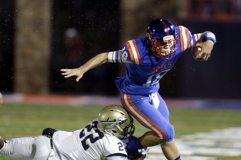 Bishop Gorman quarterback Tate Martell is tackled by St. John Bosco's Clifford Simms during...