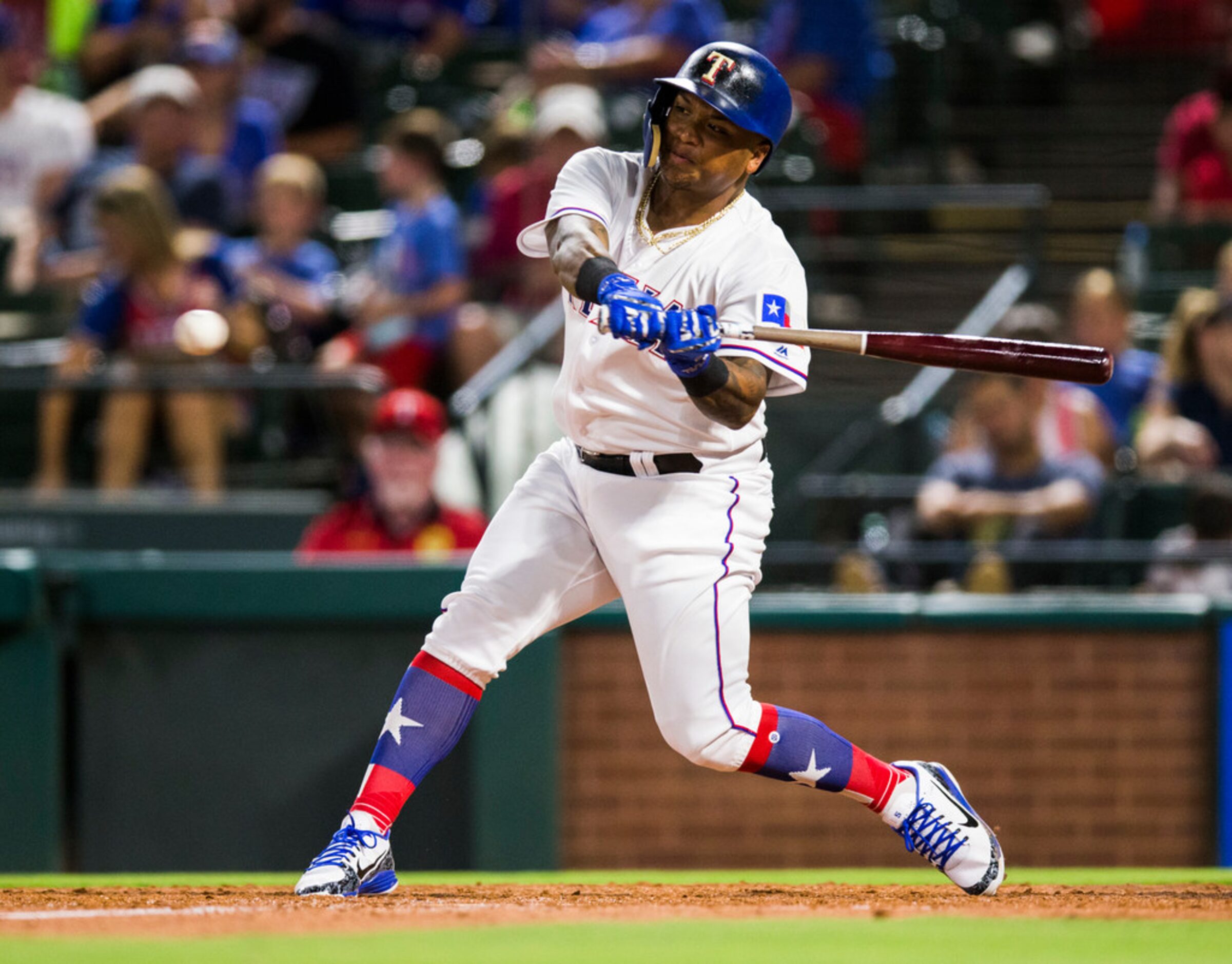 Texas Rangers left fielder Willie Calhoun (5) bats during the sixth inning of an MLB game...