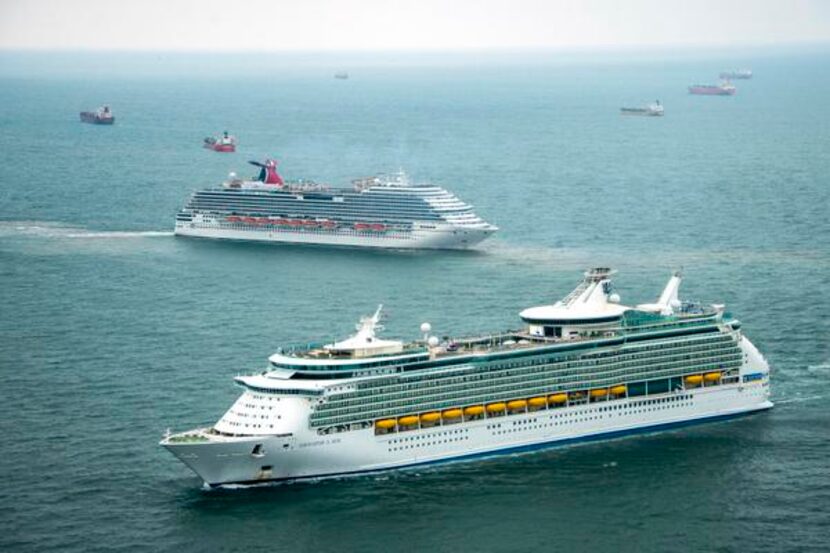 
The Royal Caribbean Navigator of the Seas and Carnival Magic sat idle Sunday with dozens of...